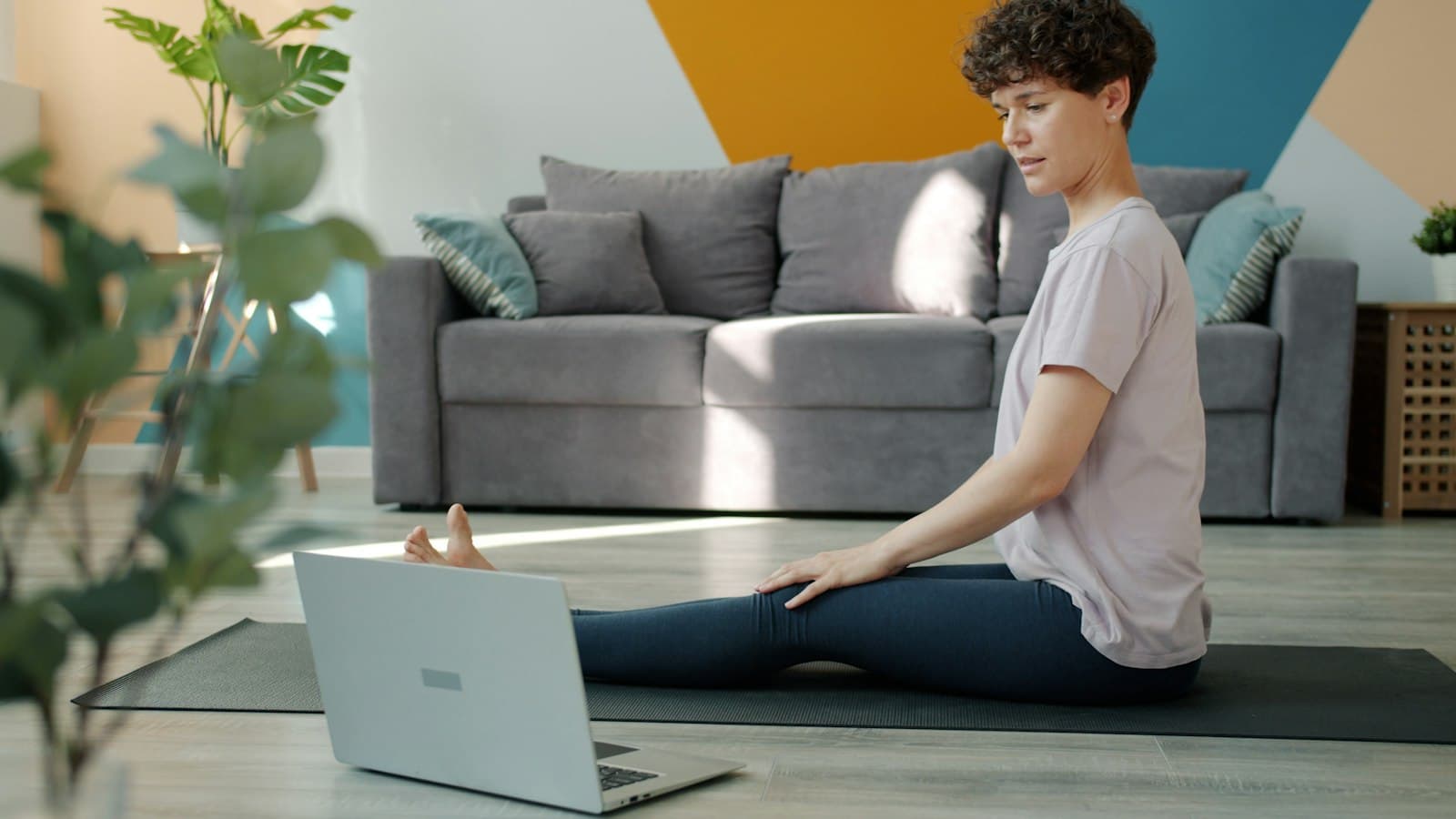 A member follows a live class from their living room